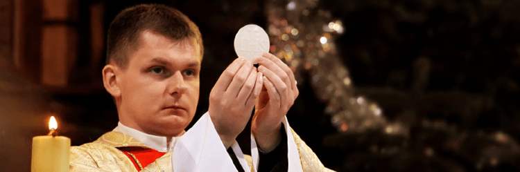 catholic priest with communion host